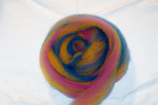 pink, yellow, and blue striped wool roving